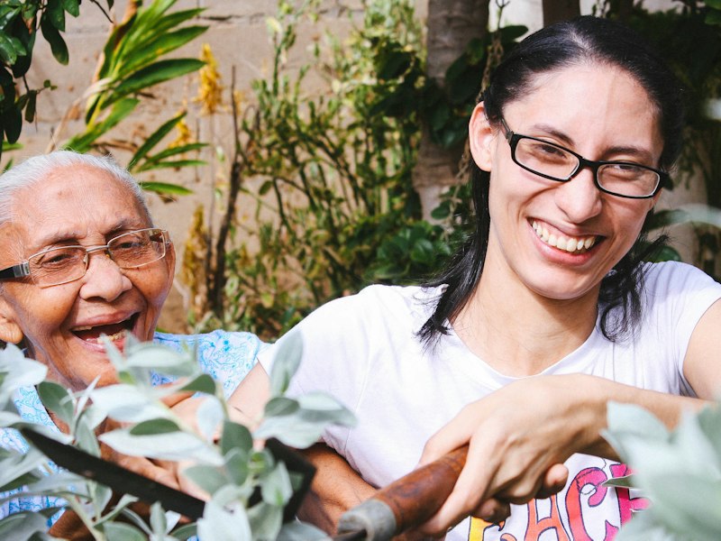 An older woman and her daughter laughing together